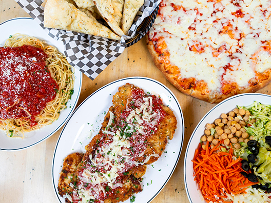 a chicken parmigiana family meal laid out for service.