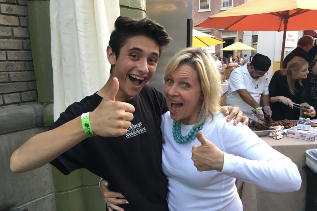 Maddy smiling with young maria's employee