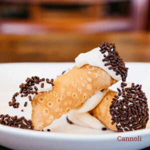 two Italian cannolis with chocolate sprinkles