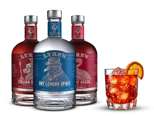 3 bottles of lyre's NA spirits next to a negroni on the rocks