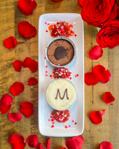 Bird's eye view of dessert surrounded by rose petals