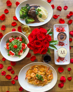 Bird's eye view of menu offerings with roses and petals