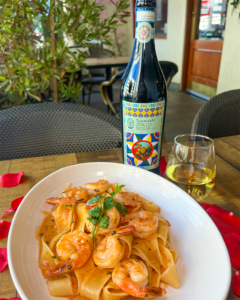 Shrimp pasta with bottle of LunaGaia