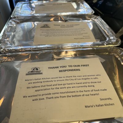 Trays of food with a heartfelt, encouraging message placed on top for the first responders